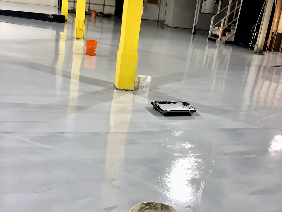 The coat going on round a yellow column at the Adventure Den dog daycare, Vancouver, the roller tray still on the floor