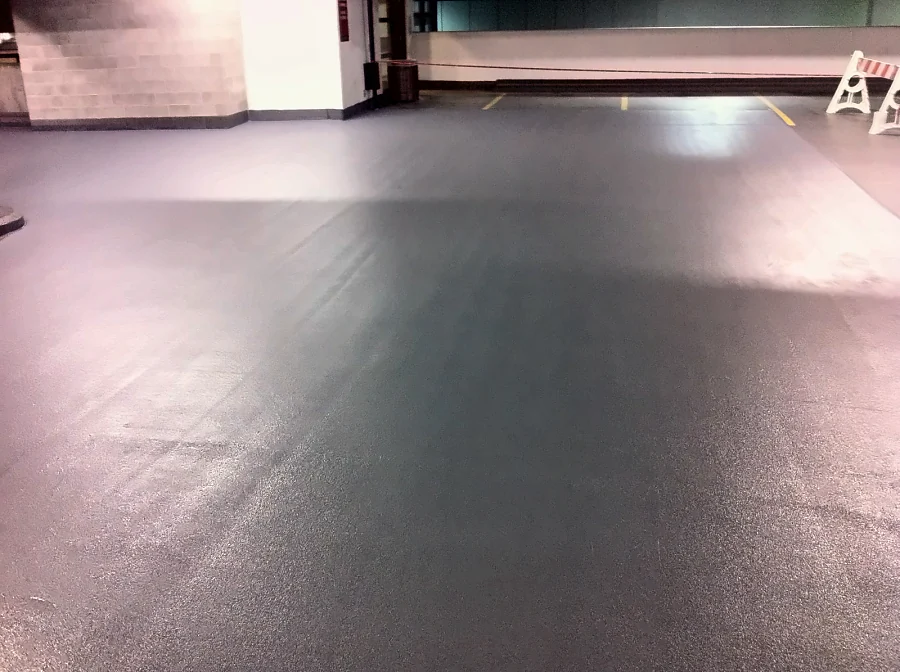 Finished grey traffic coating with a textured surface across a drive aisle of the Central City parkade in Surrey