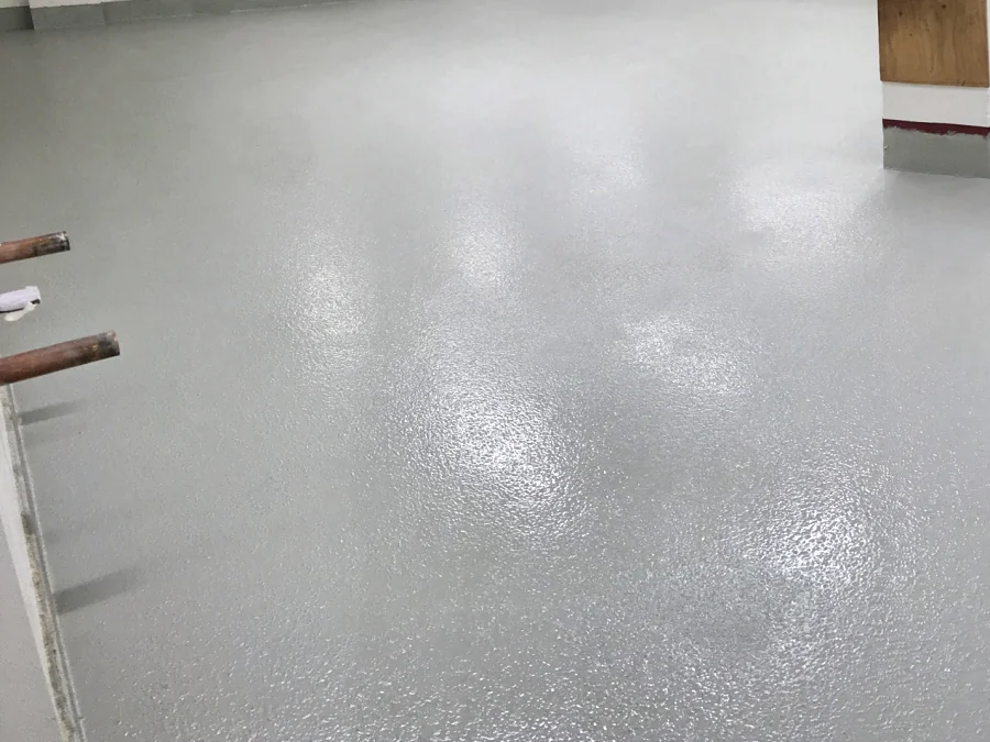 A ResinTech EWS commercial kitchen floor running to the coved base of the column