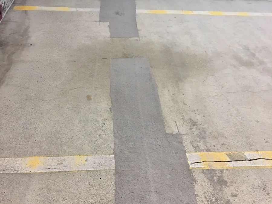 Finished Mapei Planitop 18 concrete repairs on a parkade parking level