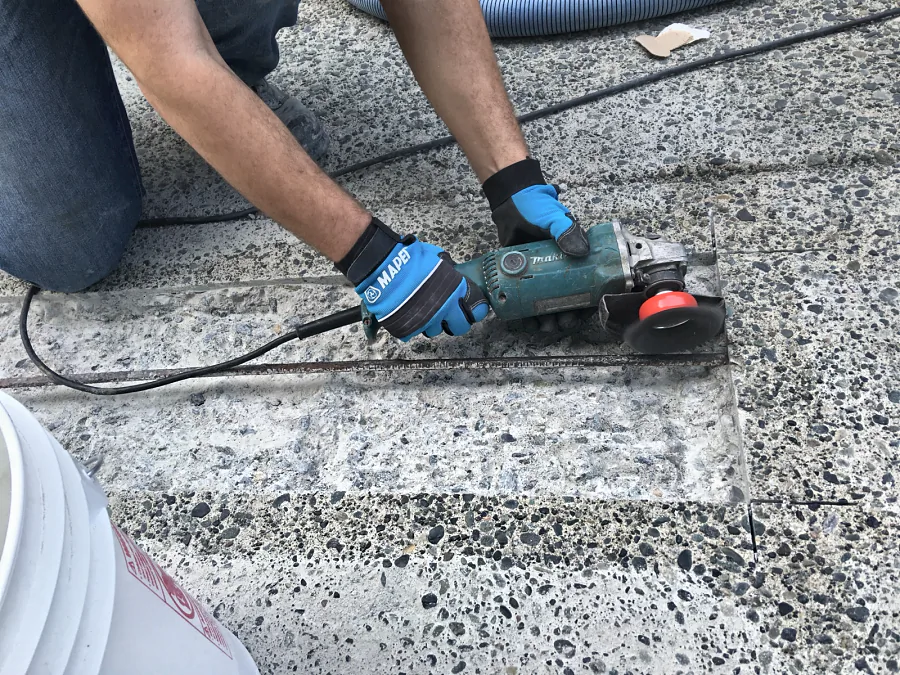 Exposed rebar in a parkade concrete repair cleaned by wire brush before Mapei Mapefer 1K rebar protection