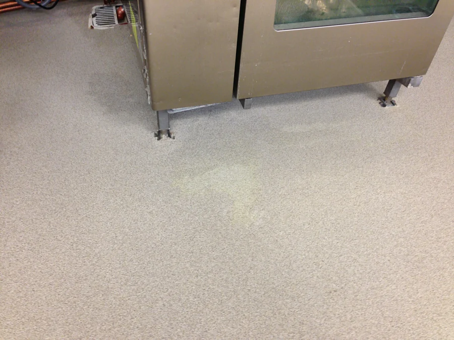 Cementitious urethane with a decorative quartz finish run under a stainless cabinet at Costco Abbotsford