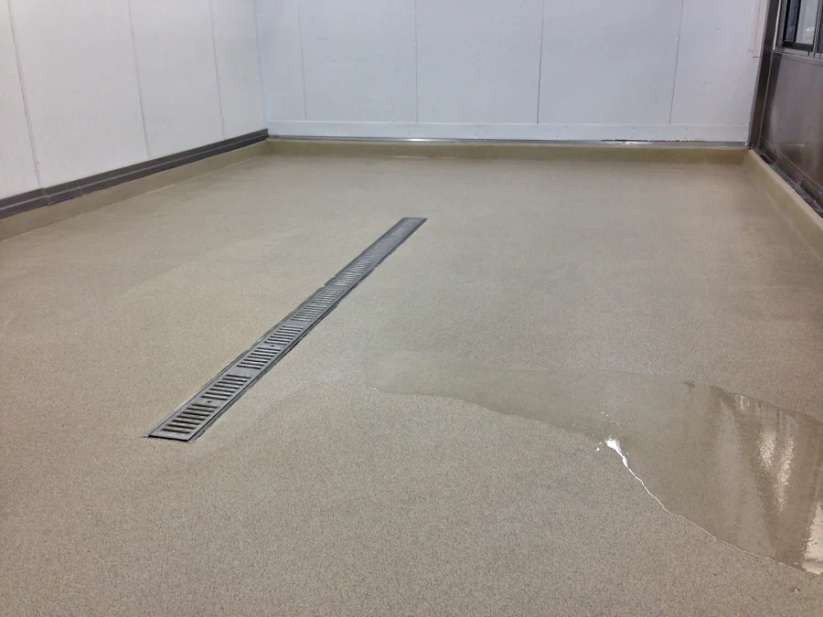 Cementitious urethane with a decorative quartz finish laid to a trench drain at Costco Abbotsford