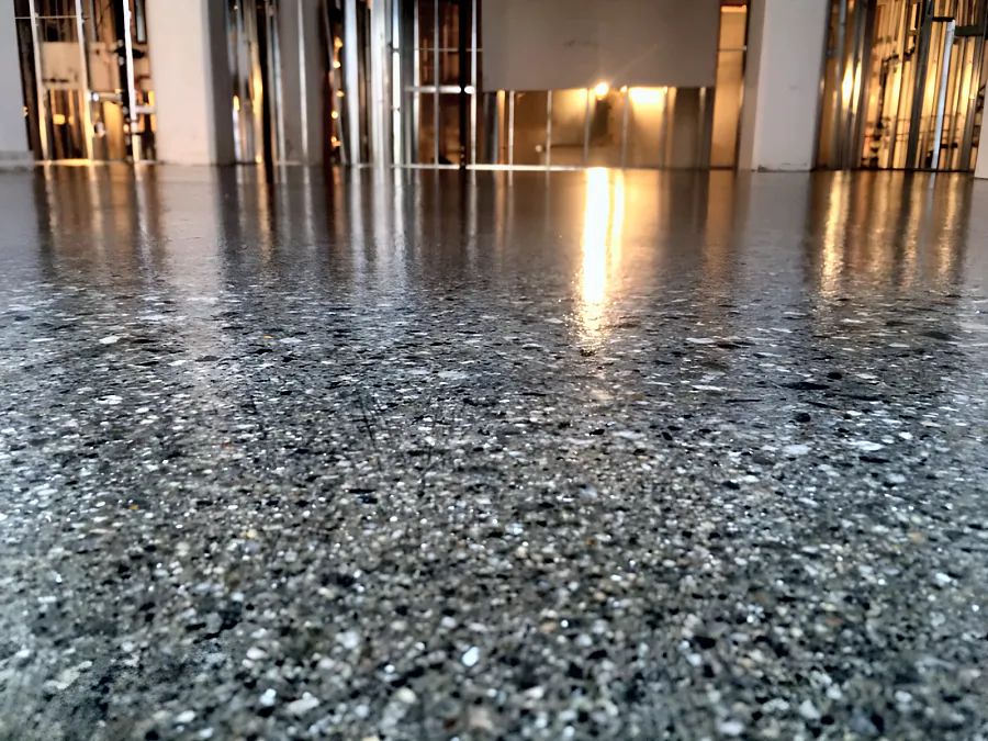 The work lights reflected in the clear epoxy and urethane coating across a Downtown Vancouver restaurant floor