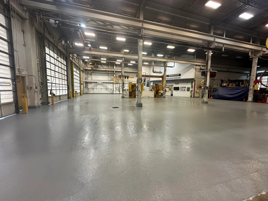 The finished grey EWS floor down the workshop, under the cranes to the far bays