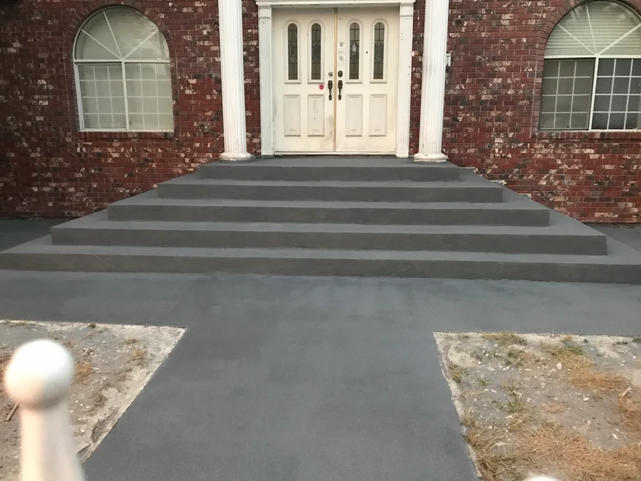 The front stairs and walkway of a house in Kerrisdale, Vancouver, finished in a dark grey ResinTech EWS quartz floor