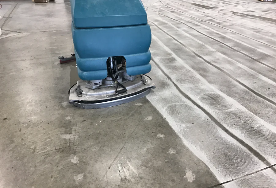 An auto-scrubber cleaning the ground concrete slab of a Kodak-owned printing company in Richmond before the floor coating