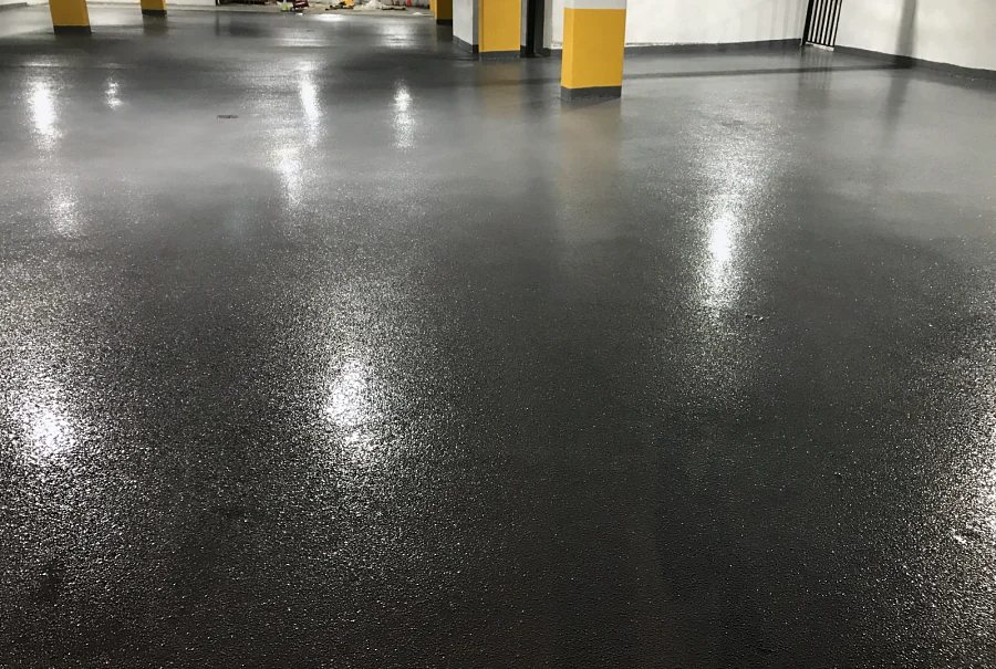 The textured, glossy finish of the Tremco Vulkem 350NF/950NF/950NF coat in the same Maple Ridge parkade, up to the columns and the wall base