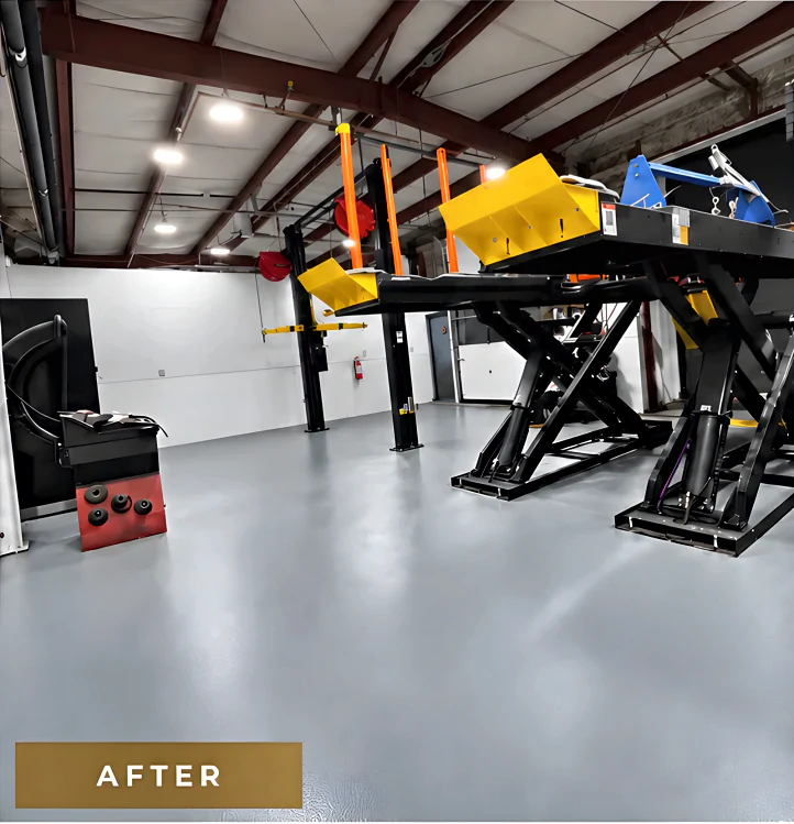 The same Richmond service bay after coating: a continuous light grey resinous floor under the scissor hoist