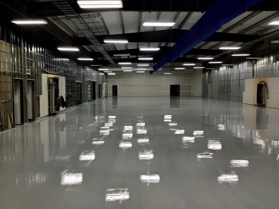 The same MTU Canada hall in Richmond after coating: a continuous high-gloss light grey epoxy and urethane floor