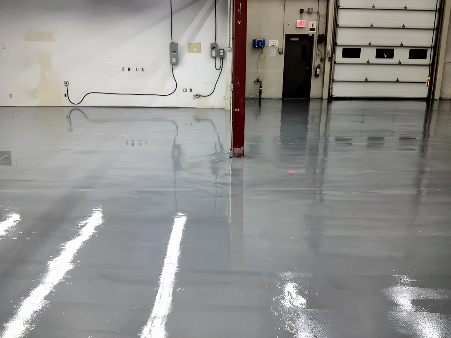 Finished high-gloss grey floor in Building 2 at MTU Maintenance Canada in Richmond, by the overhead door