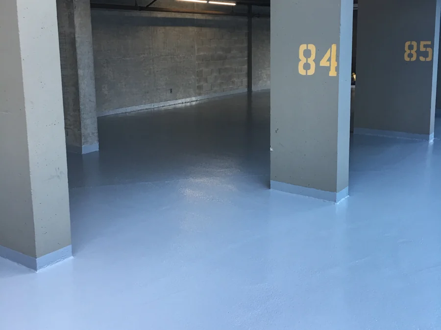 The Tremco Vulkem coat turned up the parkade columns as a coved base at the numbered stalls, New Westminster