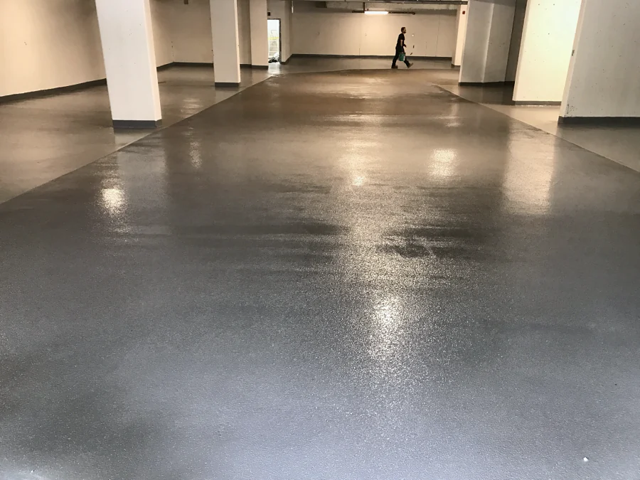 The textured grey coat down the drive aisle between the columns, 2017
