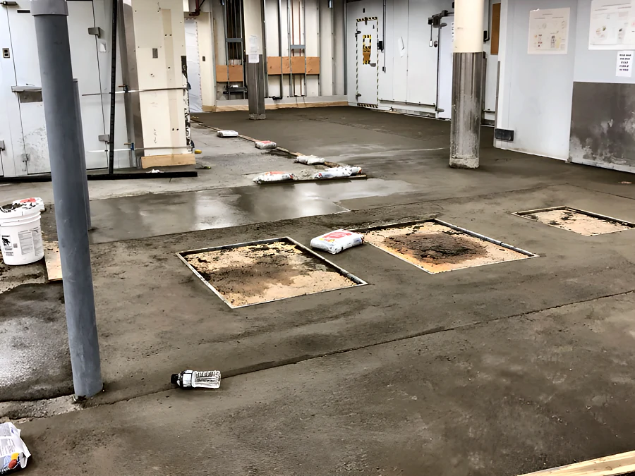 Ridge Meadows Hospital kitchen mid-renovation, the slab re-sloped to the drains in Mapei Topcem Premix