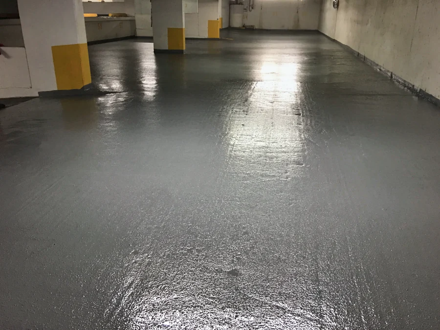 A parking level at the Sandman Hotel in Downtown Vancouver in a grey textured traffic coating, turned up the walls and the yellow-banded column bases, 2017