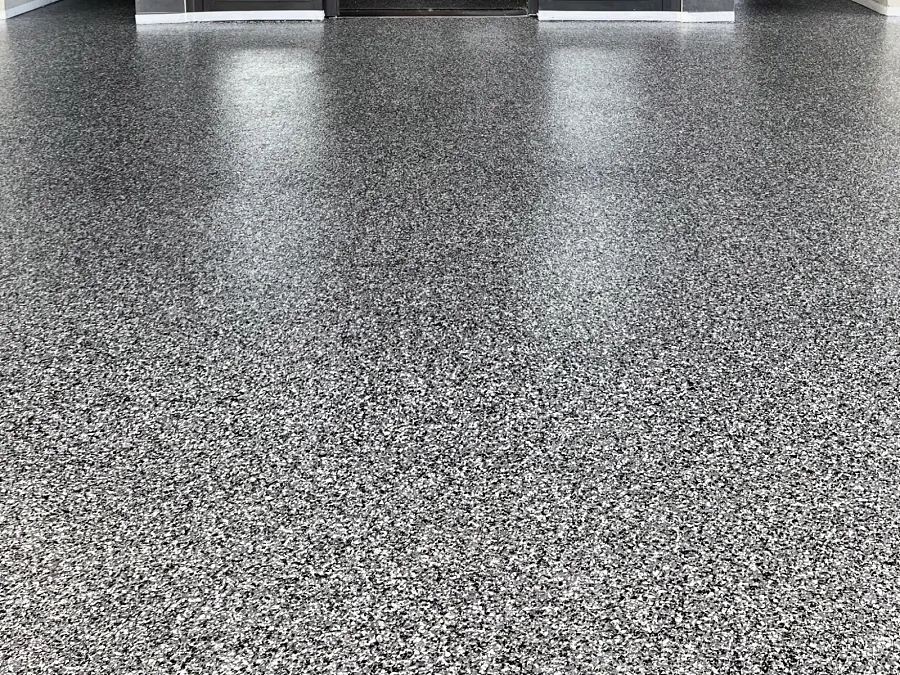 The ResinTech EWS flake finish at the Sandman Hotel entrance, a grey, black and white flake laid up to the door thresholds