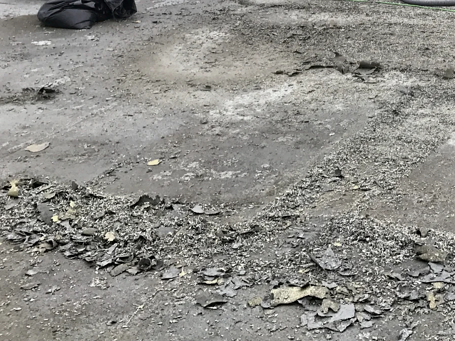 The old traffic coating ground off to the concrete on a Staples store’s rooftop parkade in Burnaby, flakes and grindings on the deck