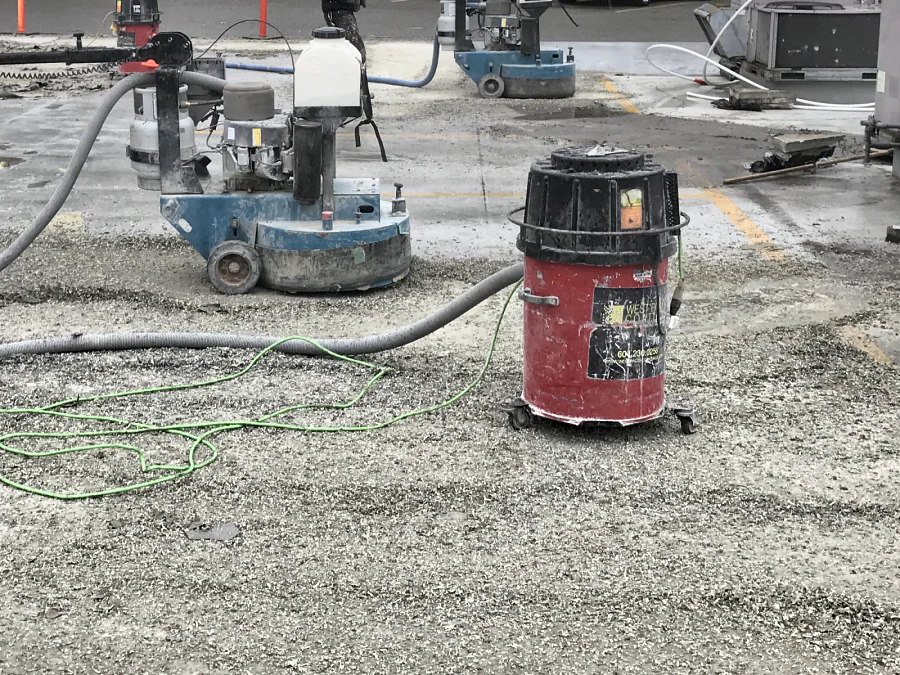 A PCD grinder taking the old traffic coating off the rooftop parkade of a Staples store in Burnaby under dust extraction, 2017