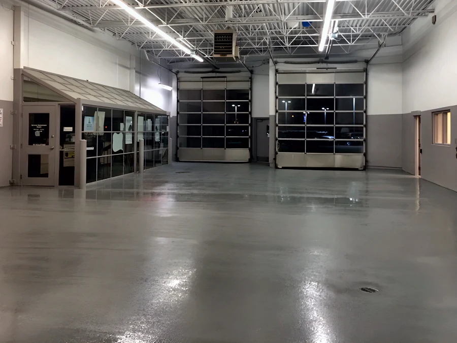 Finished grey traffic coating across the service drive of a Toyota dealership’s old shop in Vancouver, from the service office to the roll-up doors