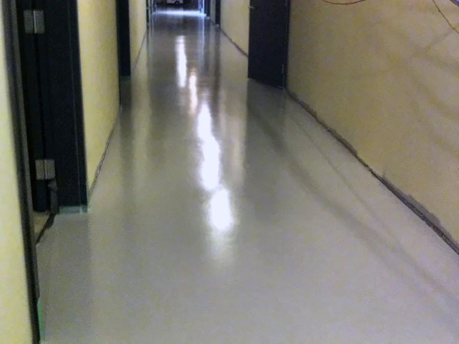 The finished light grey floor running the length of a corridor in the UBC Biological Sciences Building