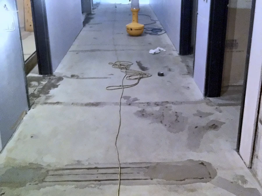 A corridor slab in the UBC Biological Sciences Building with its joints and cracks patched before the Tennant coating system