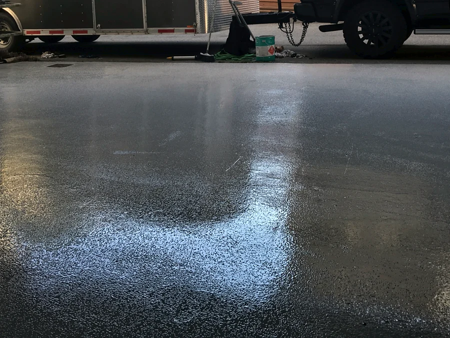 A fresh grey Tremco Vulkem 350NF/346 traffic coating glossy at the mouth of a Vancouver loading bay