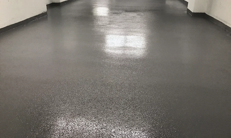 The finished Tremco Vulkem 350NF/950NF/950NF traffic coating down a drive aisle, textured and glossy