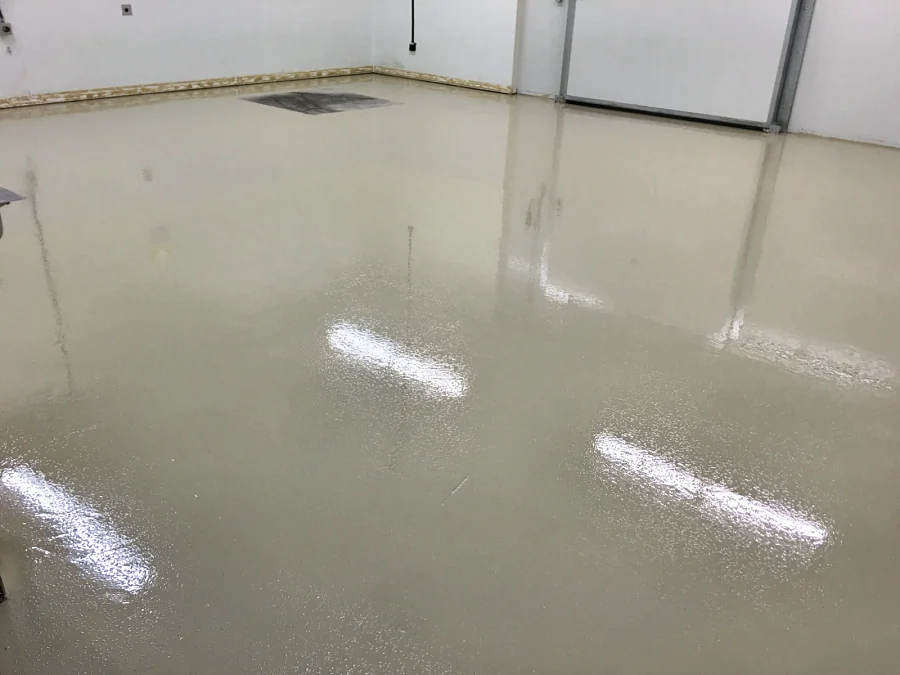 The finished ResinTech walk-in cooler floor, light and glossy across the room
