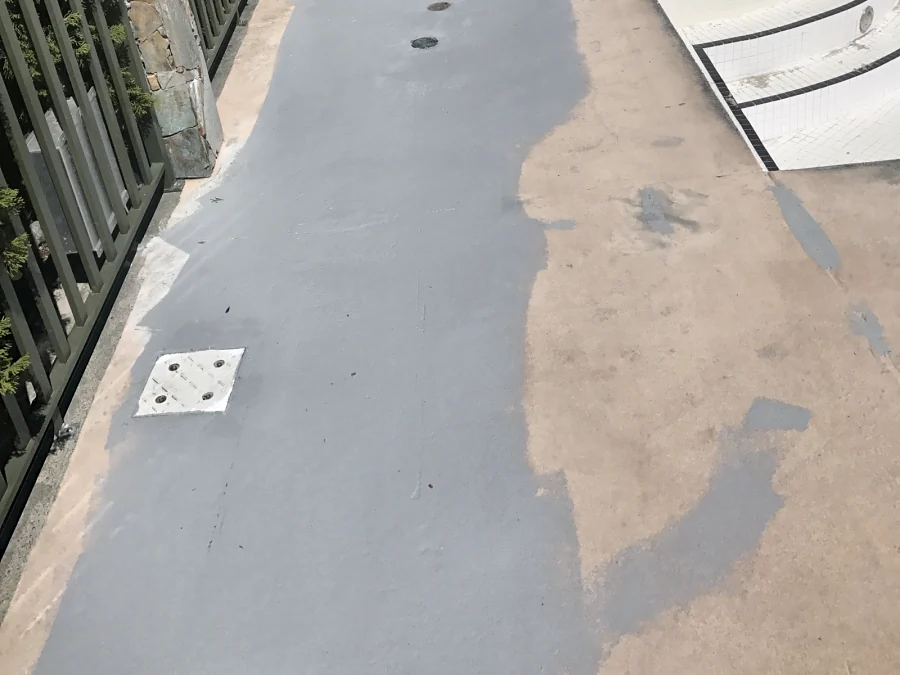Repairs patched in grey along the fence by the hot-tub steps on a Whistler hotel pool deck